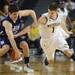 Michigan senior Stu Douglass reaches for the ball around Northwestern freshman Dave Sobolewski in the second half against Northwestern at Crisler Center on Wedensday. Melanie Maxwell I AnnArbor.com